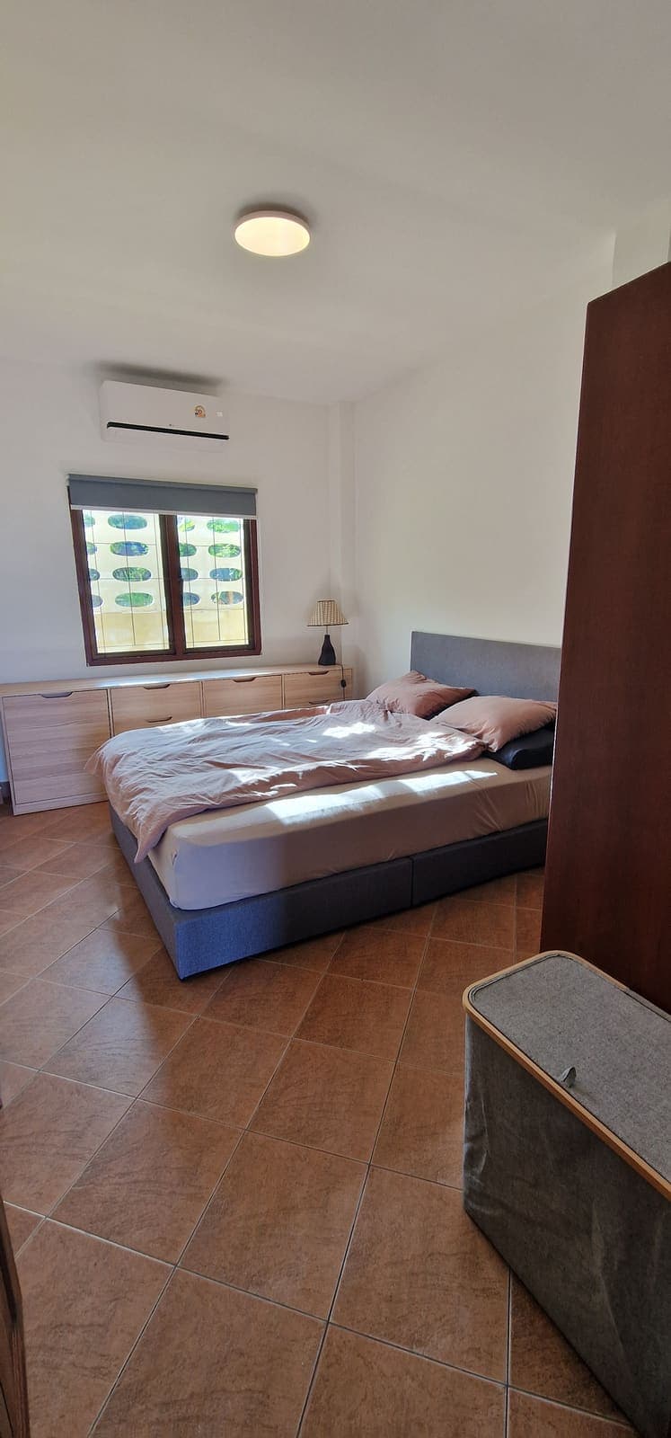 Bright bedroom with a double bed and wardrobe