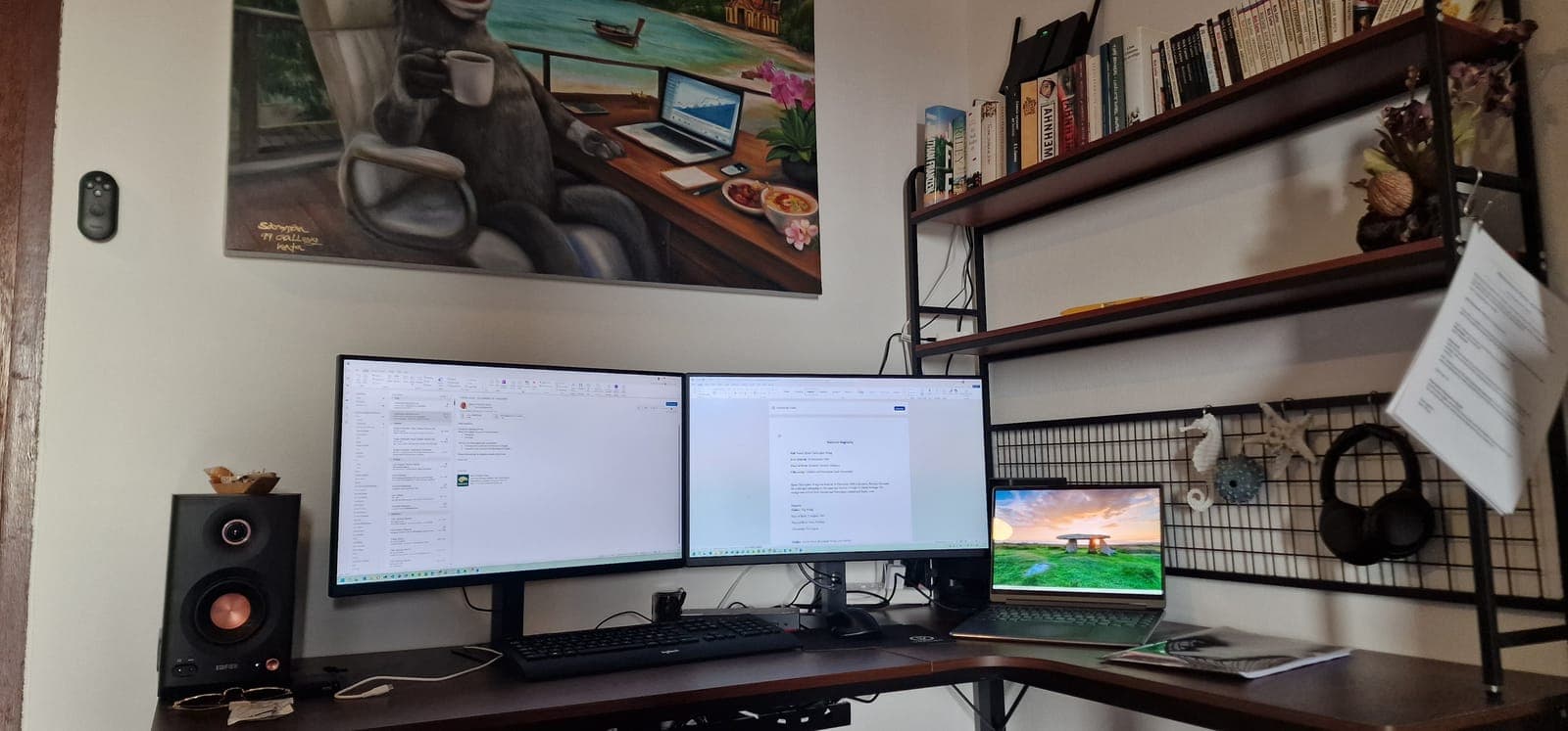 Desk with two 27-inch monitors, laptop dock and bookshelf